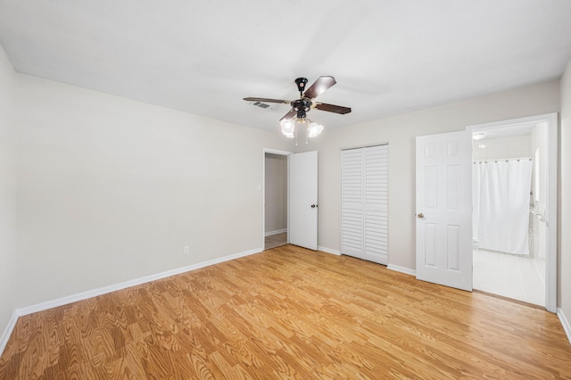 814 Tuxedo Dr, Fort Walton Beach, FL 32547 - unfurnished bedroom featuring light wood finished floors, baseboards, a closet, ceiling fan, and connected bathroom