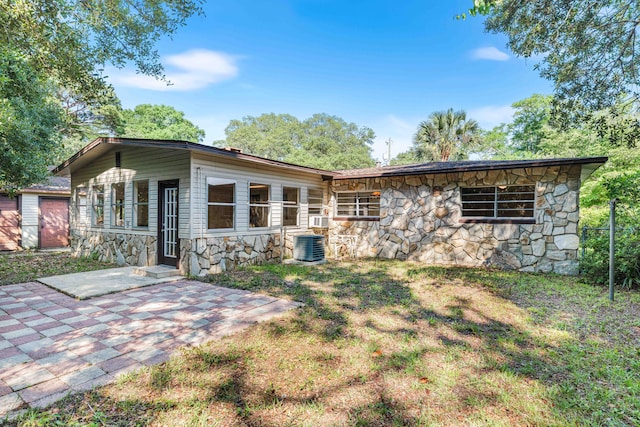814 Tuxedo Dr, Fort Walton Beach, FL 32547 - back of house with stone siding, a patio area, and cooling unit
