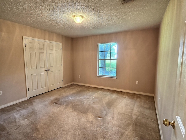 4868 Orlimar St, Crestview, FL 32536 - unfurnished bedroom featuring a closet, carpet floors, and a textured ceiling