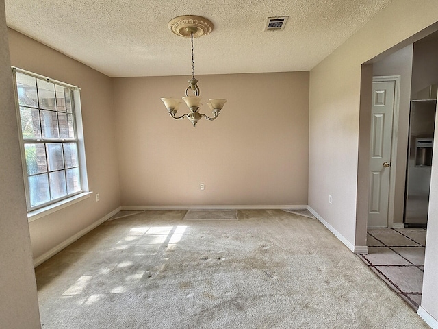 4868 Orlimar St, Crestview, FL 32536 - spare room featuring carpet floors, a chandelier, and a textured ceiling