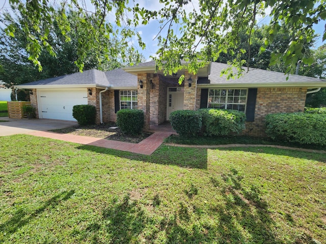 4868 Orlimar St, Crestview, FL 32536 - view of front facade featuring an attached garage, brick siding, driveway, and a front lawn