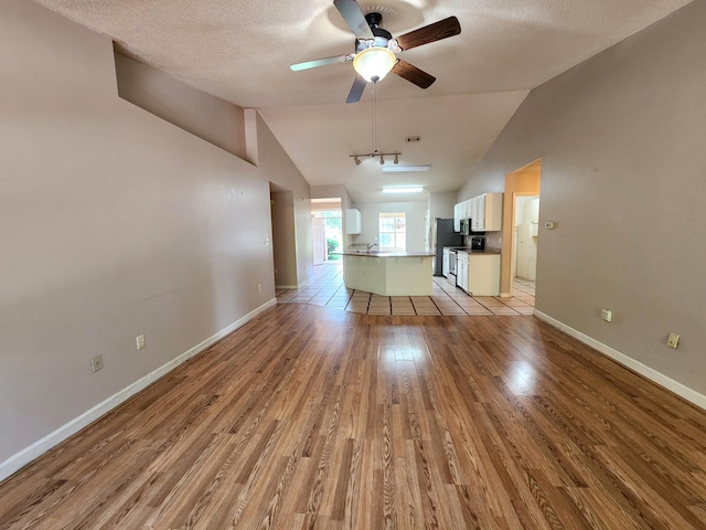 4868 Orlimar St, Crestview, FL 32536 - unfurnished living room with light wood-type flooring, a ceiling fan, a textured ceiling, and high vaulted ceiling