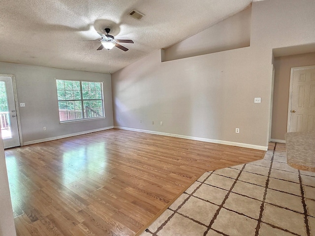 4868 Orlimar St, Crestview, FL 32536 - unfurnished living room with ceiling fan, light wood finished floors, a textured ceiling, and vaulted ceiling