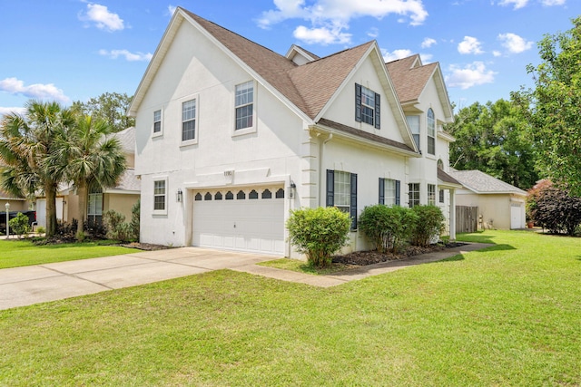 1190 Witshire Ct, Fort Walton Beach, FL 32547 - view of front facade with stucco siding, an attached garage, driveway, a front yard, and roof with shingles