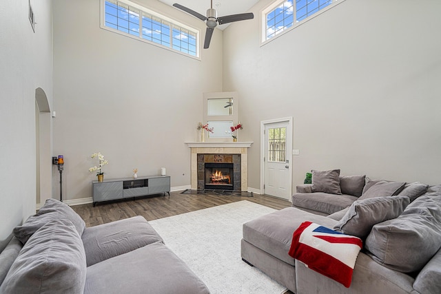 1190 Witshire Ct, Fort Walton Beach, FL 32547 - living room with a towering ceiling, a ceiling fan, wood finished floors, plenty of natural light, and arched walkways
