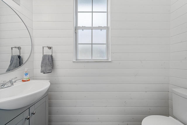 1190 Witshire Ct, Fort Walton Beach, FL 32547 - bathroom featuring vanity, toilet, and wooden walls