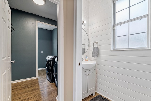 1190 Witshire Ct, Fort Walton Beach, FL 32547 - bathroom featuring separate washer and dryer, vanity, wood finished floors, baseboards, and wood walls