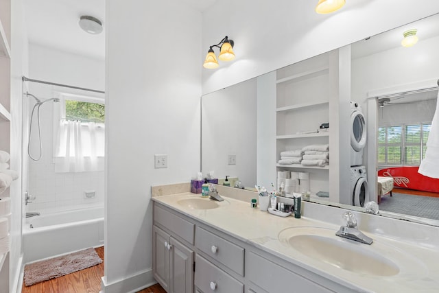 84 Old Miller Pl, Santa Rosa Beach, FL 32459 - full bath with estacked washer and dryer, double vanity, wood finished floors, and plenty of natural light