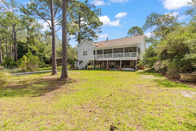 84 Old Miller Pl, Santa Rosa Beach, FL 32459 - rear view of house featuring a sunroom, a yard, and stairway