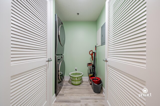112 Seascape Dr Unit 704, Miramar Beach, FL 32550 - laundry area with stacked washer and clothes dryer, light wood-style flooring, and baseboards
