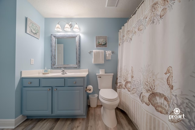 112 Seascape Dr Unit 704, Miramar Beach, FL 32550 - full bathroom with wood finished floors, toilet, vanity, and curtained shower