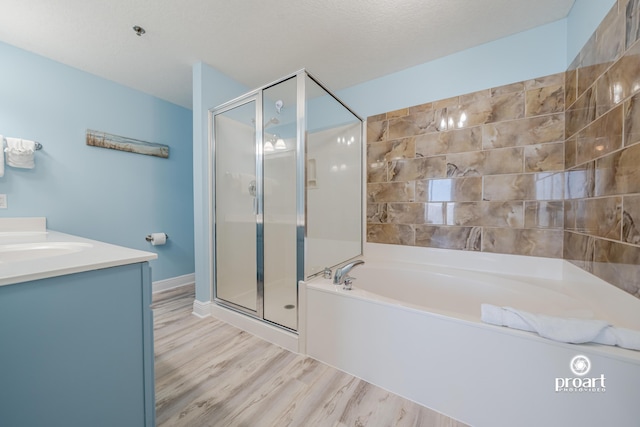 112 Seascape Dr Unit 704, Miramar Beach, FL 32550 - full bath featuring a bath, a stall shower, wood finished floors, and vanity
