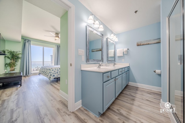 112 Seascape Dr Unit 704, Miramar Beach, FL 32550 - ensuite bathroom featuring wood finished floors, double vanity, a ceiling fan, and baseboards