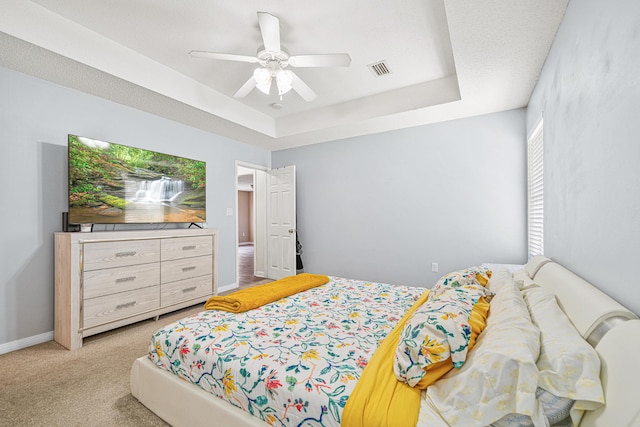 138 Conquest Ave, Crestview, FL 32536 - bedroom with a tray ceiling, carpet flooring, ceiling fan, and baseboards