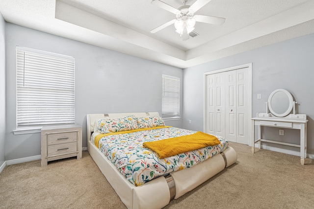 138 Conquest Ave, Crestview, FL 32536 - bedroom with carpet floors, a closet, baseboards, a raised ceiling, and ceiling fan