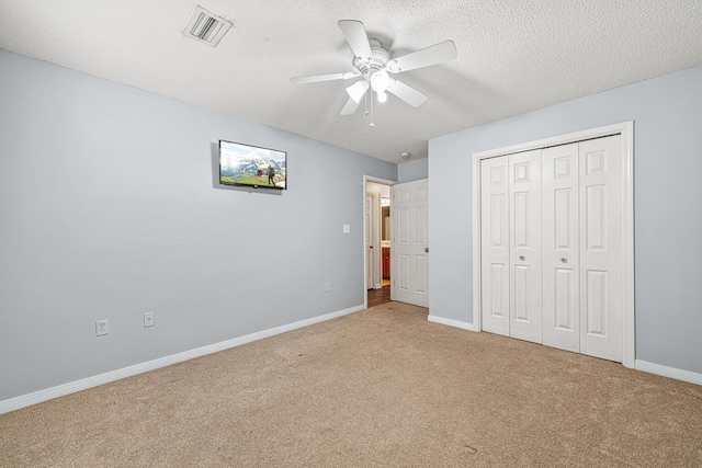 138 Conquest Ave, Crestview, FL 32536 - unfurnished bedroom featuring carpet floors, baseboards, a closet, a ceiling fan, and a textured ceiling