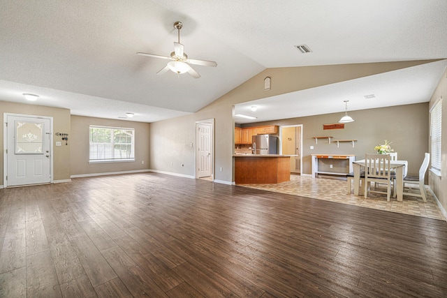 138 Conquest Ave, Crestview, FL 32536 - unfurnished living room featuring lofted ceiling, ceiling fan, wood finished floors, and baseboards