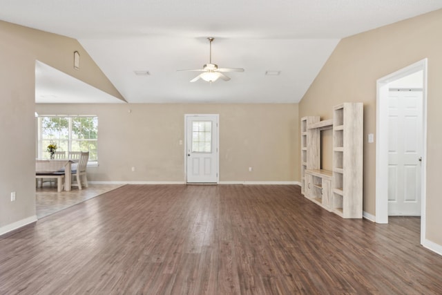 138 Conquest Ave, Crestview, FL 32536 - unfurnished living room featuring lofted ceiling, a ceiling fan, wood finished floors, healthy amount of natural light, and baseboards