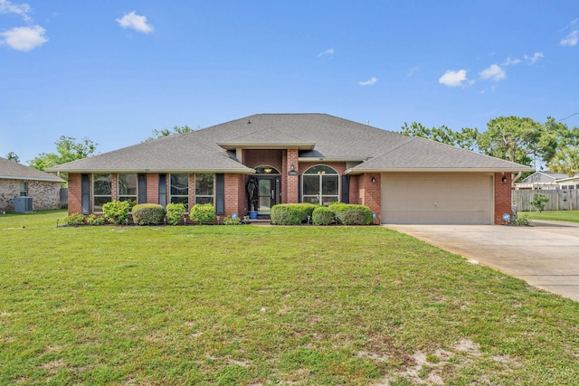 7302 Manatee St, Navarre, FL 32566 - ranch-style home with an attached garage, concrete driveway, brick siding, and roof with shingles