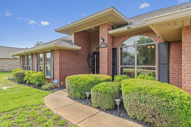 7302 Manatee St, Navarre, FL 32566 - property entrance featuring brick siding and roof with shingles
