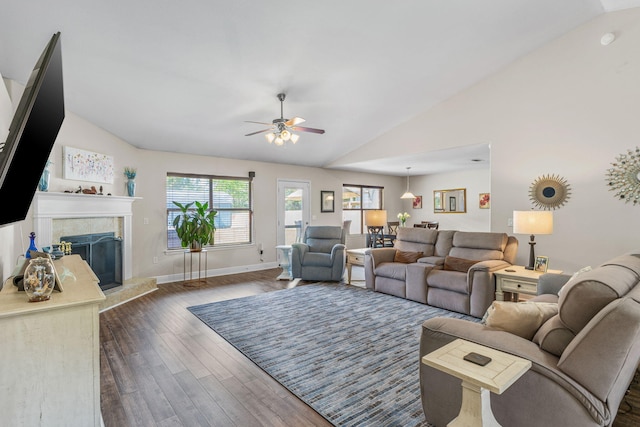 7302 Manatee St, Navarre, FL 32566 - living area with vaulted ceiling, ceiling fan, dark wood-style flooring, a fireplace, and baseboards