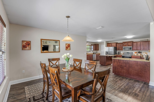 7302 Manatee St, Navarre, FL 32566 - dining area featuring dark wood finished floors and baseboards