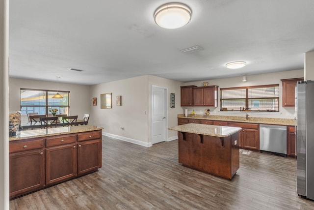 7302 Manatee St, Navarre, FL 32566 - kitchen with stainless steel appliances, baseboards, a sink, and dark wood-style flooring