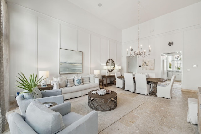 132 N Somerset St, Alys Beach, FL 32461 - living room with a chandelier, a decorative wall, and a towering ceiling