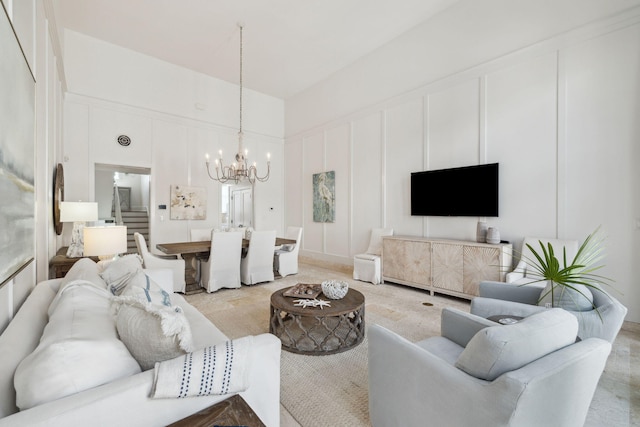 132 N Somerset St, Alys Beach, FL 32461 - living area with a chandelier, a decorative wall, and a high ceiling