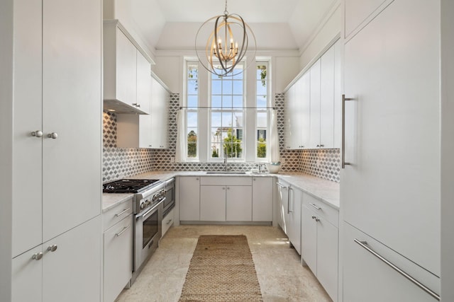 132 N Somerset St, Alys Beach, FL 32461 - kitchen featuring stainless steel appliances, a chandelier, tasteful backsplash, and a sink