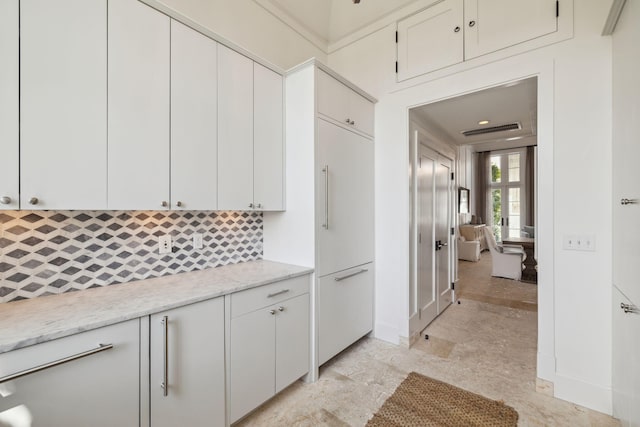 132 N Somerset St, Alys Beach, FL 32461 - kitchen with paneled built in fridge, tasteful backsplash, and white cabinetry
