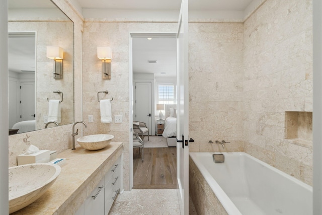 132 N Somerset St, Alys Beach, FL 32461 - bathroom with ensuite bathroom, tiled bath, double vanity, and tile walls