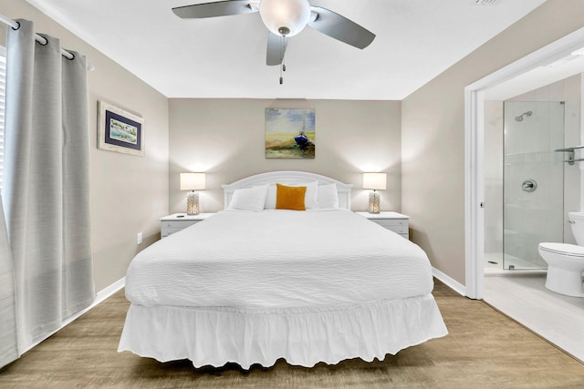 144 Spires Ln Unit 202, Santa Rosa Beach, FL 32459 - bedroom with light wood-style flooring, ensuite bathroom, baseboards, and a ceiling fan