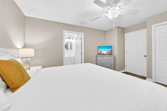 144 Spires Ln Unit 202, Santa Rosa Beach, FL 32459 - bedroom featuring connected bathroom, baseboards, and a ceiling fan