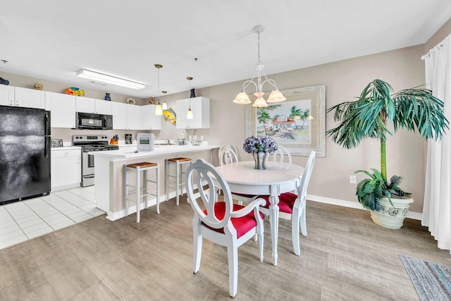 144 Spires Ln Unit 202, Santa Rosa Beach, FL 32459 - dining space with a chandelier, baseboards, and light wood-style floors