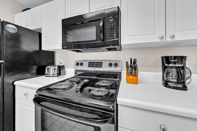 144 Spires Ln Unit 202, Santa Rosa Beach, FL 32459 - kitchen with black appliances, light countertops, and white cabinetry