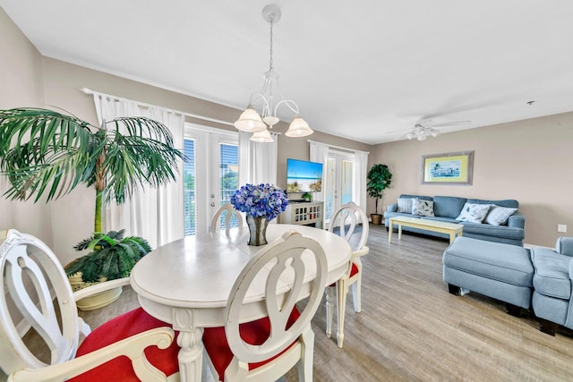 144 Spires Ln Unit 202, Santa Rosa Beach, FL 32459 - dining room with a chandelier, ceiling fan, light wood finished floors, and french doors