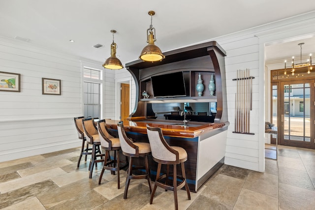 89 Shirah St, Destin, FL 32541 - kitchen with wooden walls, crown molding, and hanging light fixtures
