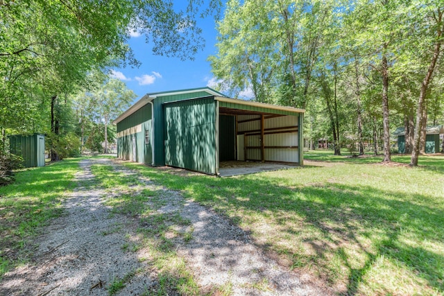 1184 Blackberry Cir, Baker, FL 32531 - view of pole building featuring a lawn, a carport, and driveway