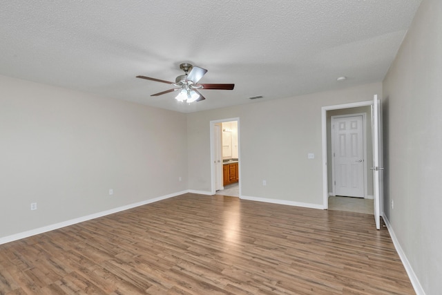 1184 Blackberry Cir, Baker, FL 32531 - spare room with ceiling fan, light wood-type flooring, baseboards, and a textured ceiling