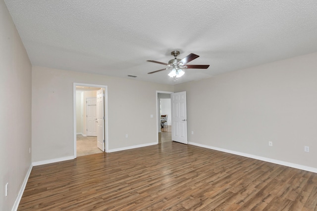 1184 Blackberry Cir, Baker, FL 32531 - unfurnished bedroom with wood finished floors, baseboards, a textured ceiling, and connected bathroom