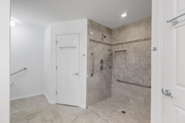 1184 Blackberry Cir, Baker, FL 32531 - bathroom with tiled shower, a textured ceiling, marble finish floors, baseboards, and recessed lighting
