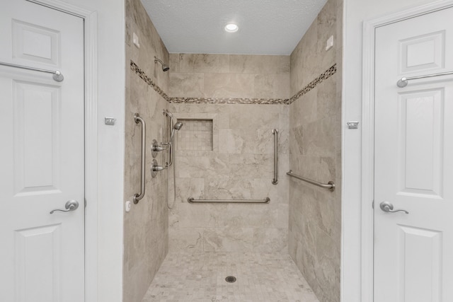 1184 Blackberry Cir, Baker, FL 32531 - full bathroom with a textured ceiling and tiled shower