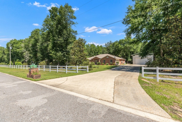1184 Blackberry Cir, Baker, FL 32531 - view of front of house featuring a garage, an outbuilding, and view of scattered trees