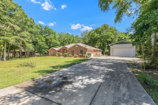 1184 Blackberry Cir, Baker, FL 32531 - view of front of house featuring a detached garage, a front yard, an outbuilding, and view of scattered trees