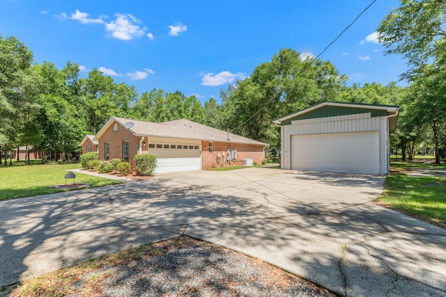 1184 Blackberry Cir, Baker, FL 32531 - ranch-style house featuring an outdoor structure, a front yard, brick siding, and a detached garage