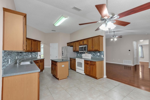 1184 Blackberry Cir, Baker, FL 32531 - kitchen with appliances with stainless steel finishes, a sink, tasteful backsplash, a center island, and ceiling fan
