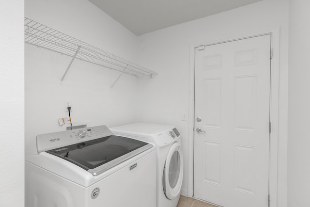 1184 Blackberry Cir, Baker, FL 32531 - laundry room with washing machine and clothes dryer and light tile patterned floors