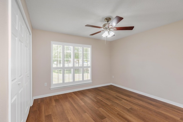 1184 Blackberry Cir, Baker, FL 32531 - unfurnished bedroom with a closet, baseboards, dark wood finished floors, and ceiling fan
