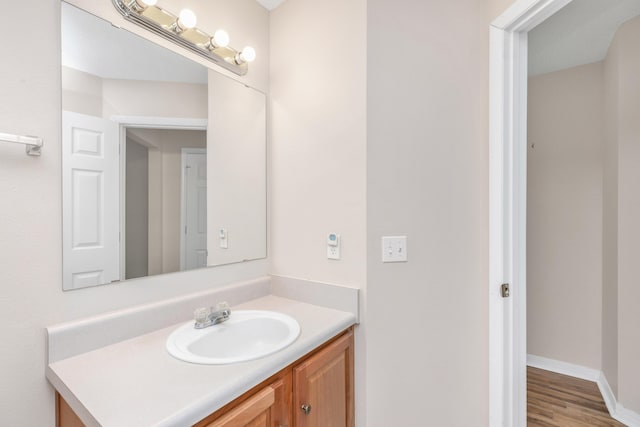 1184 Blackberry Cir, Baker, FL 32531 - bathroom with vanity, wood finished floors, and baseboards